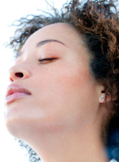 girl outside with eyes closed in meditative state